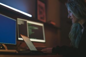 Free Side View of a Woman Using a Laptop Stock Photo