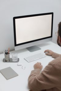 Free Crop man working on computer in workplace Stock Photo